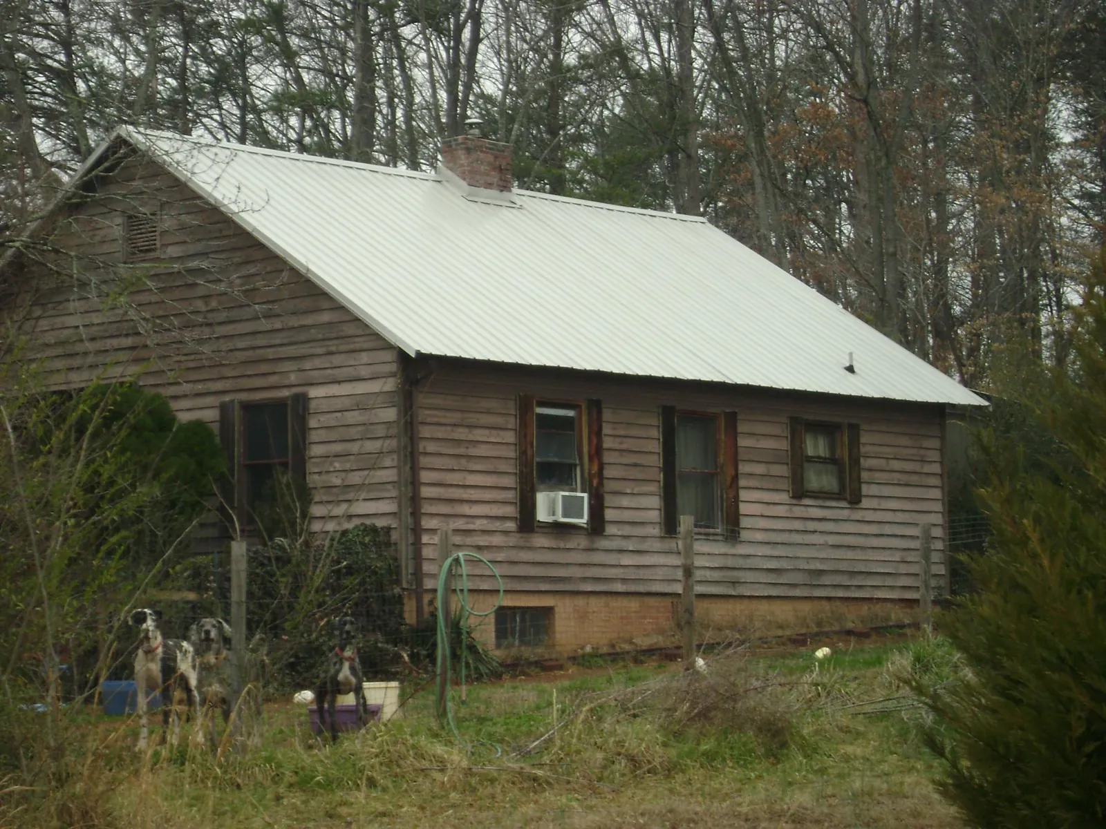 White metal roof on an old wood sided farmhouse, from a Metal Roof Installation job in Hanover